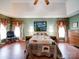 A delightful primary bedroom with lovely decor, a decorative ceiling fan, and wood flooring is picture perfect at 2547 Bill Thompson Rd, Lancaster, SC 29720