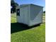 A white storage shed sits on green grass in a fenced yard; room for extra storage at 2547 Bill Thompson Rd, Lancaster, SC 29720