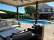 Outdoor pool area featuring comfortable wicker seating and a well-maintained lawn at 3000 J R Ct, Stanley, NC 28164