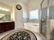 Bright bathroom featuring a soaking tub, a separate shower, and double vanity sink at 3000 J R Ct, Stanley, NC 28164