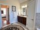 Cozy bathroom with tiled floors, a dark wood vanity, and a doorway to the main bedroom at 3000 J R Ct, Stanley, NC 28164