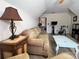 Cozy bonus room with comfortable sofa, exercise bike, and decorative lamp for relaxation and fitness at 3000 J R Ct, Stanley, NC 28164
