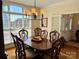 Bright dining room with large window and classic wooden table with decorative chairs at 3000 J R Ct, Stanley, NC 28164