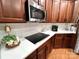 Updated kitchen with white countertops, subway tile backsplash, and dark wood cabinets at 3000 J R Ct, Stanley, NC 28164