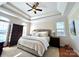 Spacious main bedroom featuring tray ceilings and abundant natural light from large windows at 3000 J R Ct, Stanley, NC 28164