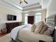 Comfortable main bedroom with tray ceilings, natural light, and an upholstered bed at 3000 J R Ct, Stanley, NC 28164