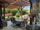 Inviting outdoor area featuring a dining table, fireplace, and comfortable seating area at 3000 J R Ct, Stanley, NC 28164