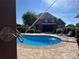 Inviting in-ground pool with comfortable lounge seating and a covered outdoor kitchen perfect for outdoor entertaining and relaxation at 3000 J R Ct, Stanley, NC 28164