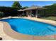 Inviting in-ground pool area with an outdoor kitchen and covered patio with seating at 3000 J R Ct, Stanley, NC 28164