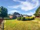 Expansive backyard features an in-ground pool, lush lawn, mature trees and landscaping, and a wood fence at 3124 Fairmead Dr, Concord, NC 28025