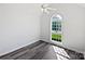 A bright bedroom featuring an arched window and durable laminate flooring at 3124 Fairmead Dr, Concord, NC 28025
