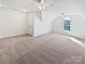 Spacious bonus room with plush carpeting, natural light, and vaulted ceilings at 3124 Fairmead Dr, Concord, NC 28025