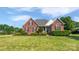 Charming brick home with manicured lawn, detailed landscaping, and traditional architectural details at 3124 Fairmead Dr, Concord, NC 28025