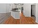 Modern kitchen featuring white cabinets, wood flooring, and stainless steel appliances at 3124 Fairmead Dr, Concord, NC 28025