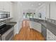 Bright kitchen with white cabinetry, stainless appliances, and view of backyard pool at 3124 Fairmead Dr, Concord, NC 28025