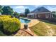 Beautiful backyard with an in-ground pool and a home with a screened porch at 3124 Fairmead Dr, Concord, NC 28025