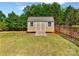 A backyard storage shed features double doors, windows, and a wooden ramp at 3124 Fairmead Dr, Concord, NC 28025