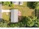 Aerial view showcases the home, spacious backyard, patio, and shed, all surrounded by lush greenery at 322 S Vine St, Gastonia, NC 28052
