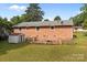 Brick home's backyard featuring a shed, patio, and fenced yard, offering ample outdoor space at 322 S Vine St, Gastonia, NC 28052