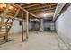 Unfinished basement with exposed ductwork and a staircase, offering potential for customization at 322 S Vine St, Gastonia, NC 28052