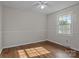 Cozy bedroom featuring hardwood floors, a ceiling fan, and a sunlit window at 322 S Vine St, Gastonia, NC 28052