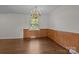 Elegant dining room featuring hardwood floors, wainscotting and a decorative chandelier at 322 S Vine St, Gastonia, NC 28052