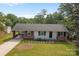 Charming single-story home featuring a cozy carport, brick accents and well-maintained landscaping at 322 S Vine St, Gastonia, NC 28052