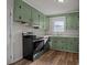 Functional kitchen featuring green cabinets, modern appliances, and durable countertops at 322 S Vine St, Gastonia, NC 28052
