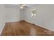 Bright living room with hardwood floors, a ceiling fan, and a large window with natural light at 322 S Vine St, Gastonia, NC 28052