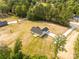 Aerial view of a home, showing the backyard and surrounding green space and driveway at 3650 Sentry Rd, Lancaster, SC 29720