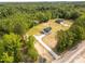 Expansive aerial view of a single-Gathering home on a spacious lot surrounded by lush greenery and a long driveway at 3650 Sentry Rd, Lancaster, SC 29720