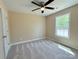Carpeted bedroom with natural light from a window and a ceiling fan at 3650 Sentry Rd, Lancaster, SC 29720