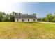 Back exterior view of a home, featuring a well-maintained lawn and a wooden deck at 3650 Sentry Rd, Lancaster, SC 29720