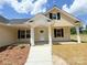Inviting porch with columns and a neatly landscaped yard leading to the front door at 3650 Sentry Rd, Lancaster, SC 29720