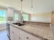 Granite countertop featuring a sink and stylish faucet, complemented by ample natural light at 3650 Sentry Rd, Lancaster, SC 29720
