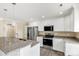 Modern kitchen features stainless steel appliances, granite countertops, and white cabinetry at 3650 Sentry Rd, Lancaster, SC 29720