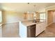 Open kitchen with granite island, stainless steel appliances, and hardwood floors at 3650 Sentry Rd, Lancaster, SC 29720