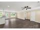 Spacious living room featuring modern gray flooring and an adjacent kitchen area at 3650 Sentry Rd, Lancaster, SC 29720