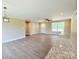 Spacious living room with hardwood floors, ceiling fan, and natural light at 3650 Sentry Rd, Lancaster, SC 29720