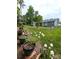 Well-manicured backyard with flowers in planters and view of outbuilding at 414 Fulton Dr, Kings Mountain, NC 28086