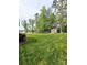 Expansive backyard features lush green lawn and a charming storage shed, perfect for outdoor activities at 414 Fulton Dr, Kings Mountain, NC 28086