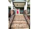 Inviting front entrance with brick steps and railings leading to a charming front porch at 414 Fulton Dr, Kings Mountain, NC 28086