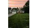 Dusk view of home's green exterior, well-kept lawn, landscaped front yard and attached garage at 414 Fulton Dr, Kings Mountain, NC 28086