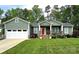 Charming single-Gathering home with green siding, white garage door and well-manicured lawn and landscaping at 414 Fulton Dr, Kings Mountain, NC 28086