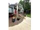 Front porch with a brick base, white columns, wrought iron railings, and landscaping at 414 Fulton Dr, Kings Mountain, NC 28086