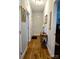 Hallway has hardwood floors, neutral paint and light from a table lamp at 414 Fulton Dr, Kings Mountain, NC 28086
