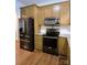 Well-equipped kitchen features stainless appliances, granite counters, tile backsplash and attractive cabinetry at 414 Fulton Dr, Kings Mountain, NC 28086