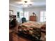 Main bedroom has wood floors, a quilt-covered bed and windows with plantation shutters at 414 Fulton Dr, Kings Mountain, NC 28086