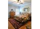 Main bedroom has wood floors, a quilt-covered bed and windows with plantation shutters at 414 Fulton Dr, Kings Mountain, NC 28086