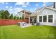 Fenced-in backyard with a seating area, grill, and manicured lawn for outdoor enjoyment at 432 Belton St, Charlotte, NC 28209